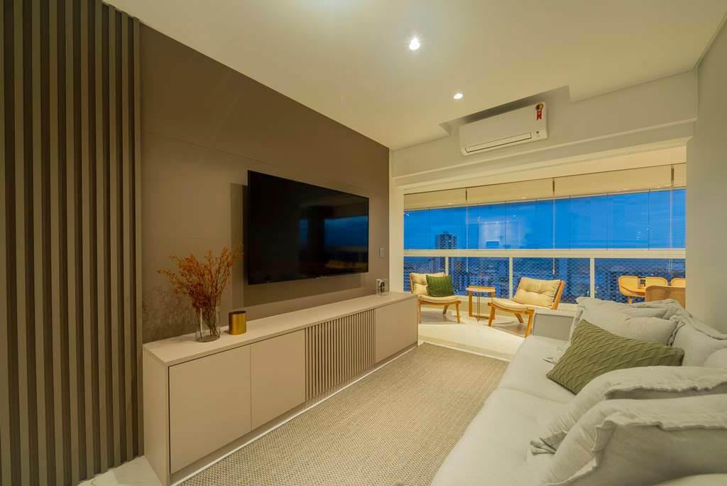 Sala de estar com painel ripado e rack planejado